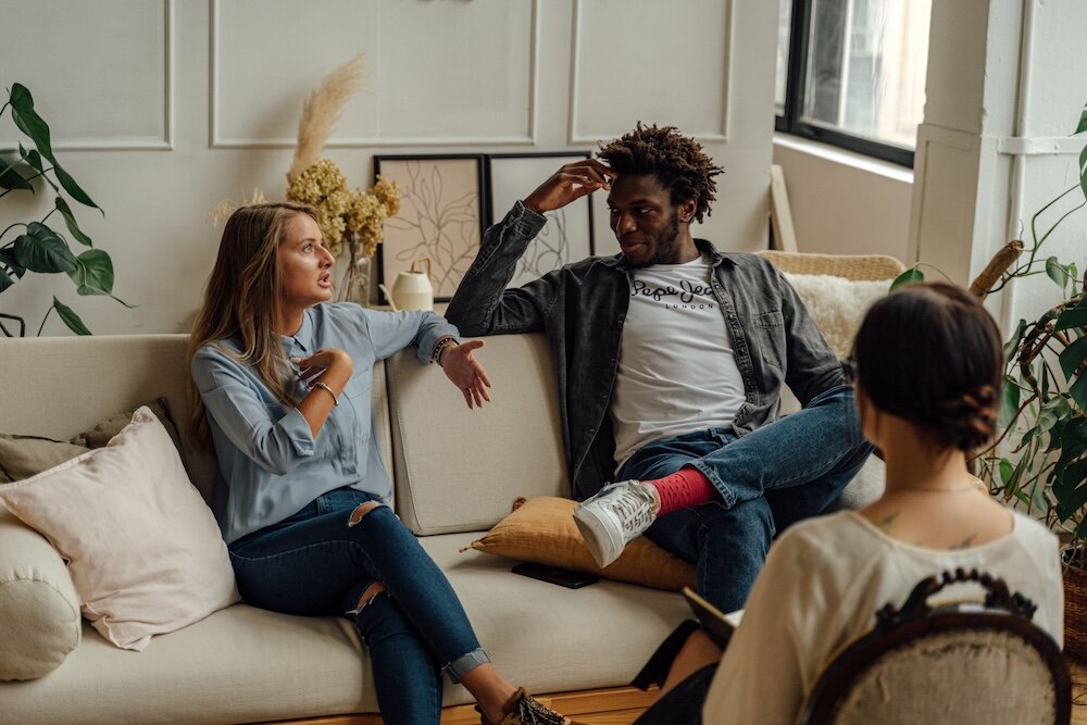 Patient thoughtfully speaking with psychotherapist