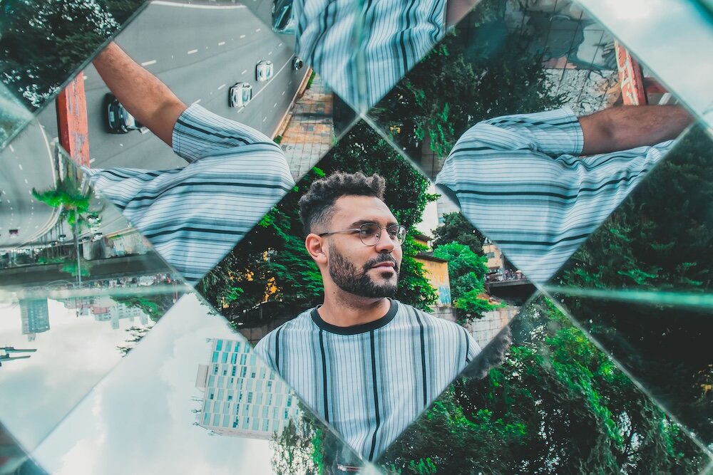 Person reflected in multiple mirrors