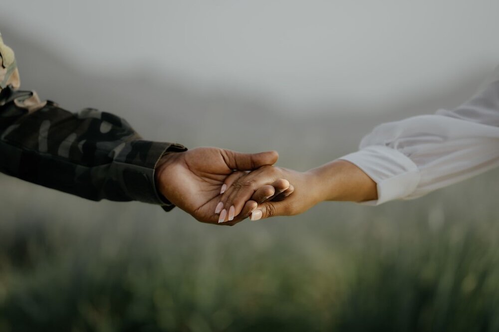 Two people holding hands