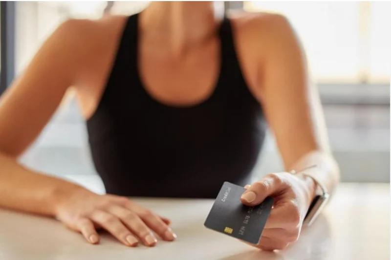 Woman holding credit card for payment