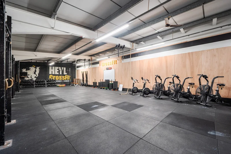Modern CrossFit box with industrial equipment and natural lighting