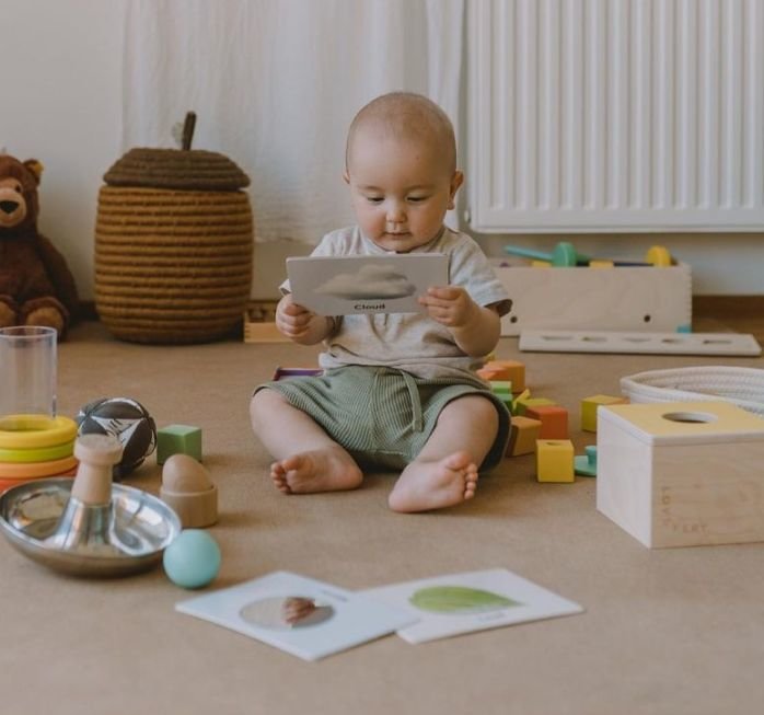 Toddler girl playing with Lovevery toy