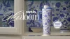White Owala Heirloom FreeSip Tumbler with porcelain-inspired blue pattern sitting in a cupboard