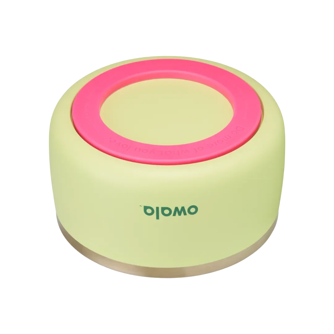 Owala Pet Bowl, bottom view showing chartreuse silicone cup exterior with hot pink accent ring embossed with "Do more of what you love" and thin stainless steel band at rim, green Owala logo on cup side