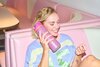 A girl holding an Owala FreeSip to her ear