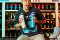 One man holding two Owala freeSips