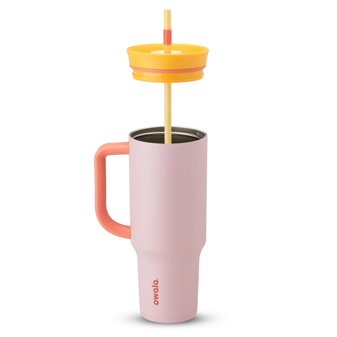 Owala Tumbler 40oz in Candy Store, soft pink insulated stainless steel tumbler with coral pink side handle, orange lid, and cream straw slider with yellow straw and coral grip