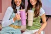 Two girls posing while each holding a pink and tan Owala 40oz tumbler.