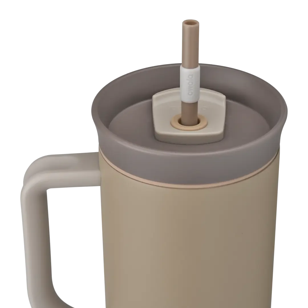 Owala Tumbler 40oz close-up in Down To Earth, taupe body with matching tan side handle, mauve-taupe lid with copper accent ring, and tan straw with white grip