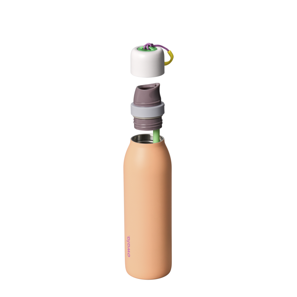 Owala FreeSip Twist 18oz in Peachy Keen, exploded view showing peach-orange body, white twist cap floating above with purple carry string and yellow carry string grip, mauve FreeSip spout, and green straw