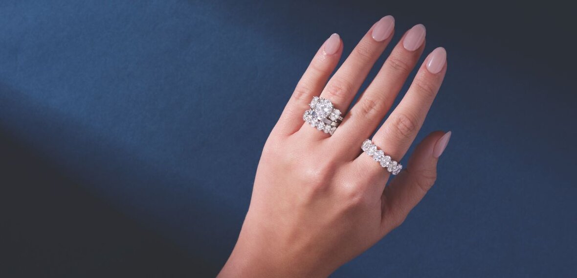 White and yellow gold diamond wedding bands styled on lace fabric, showcasing elegant bridal ring designs by Wedding Bands & Co. in Chicago