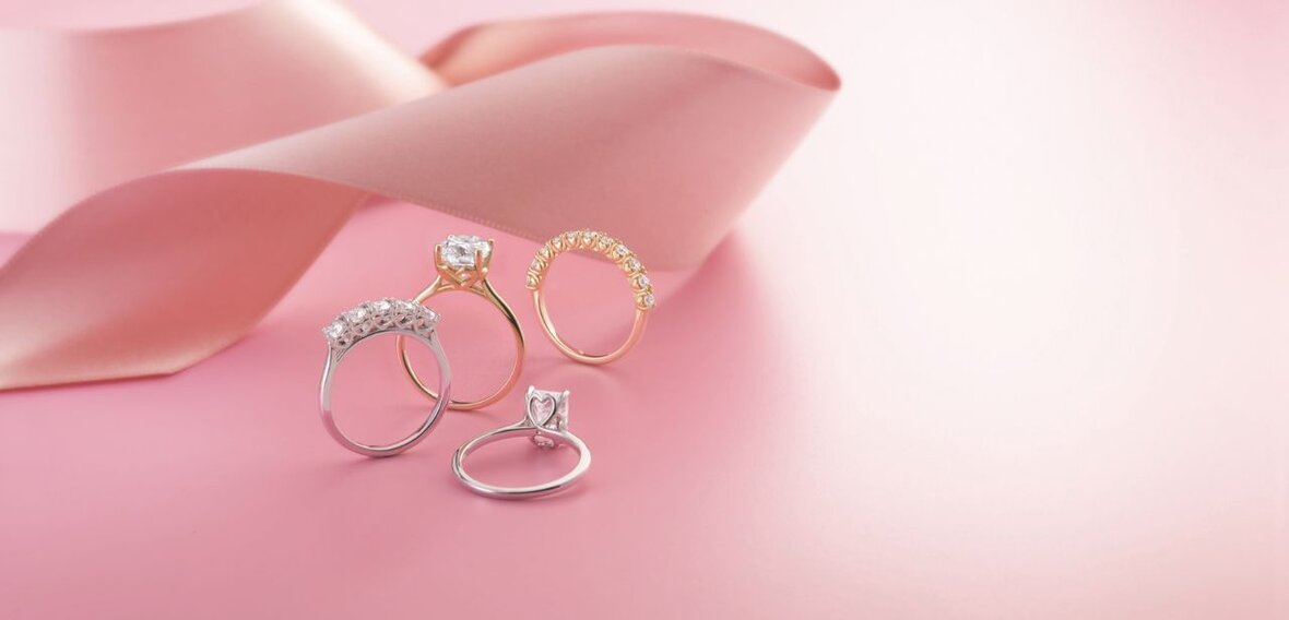 White and yellow gold diamond wedding bands styled on lace fabric, showcasing elegant bridal ring designs by Wedding Bands & Co. in Chicago