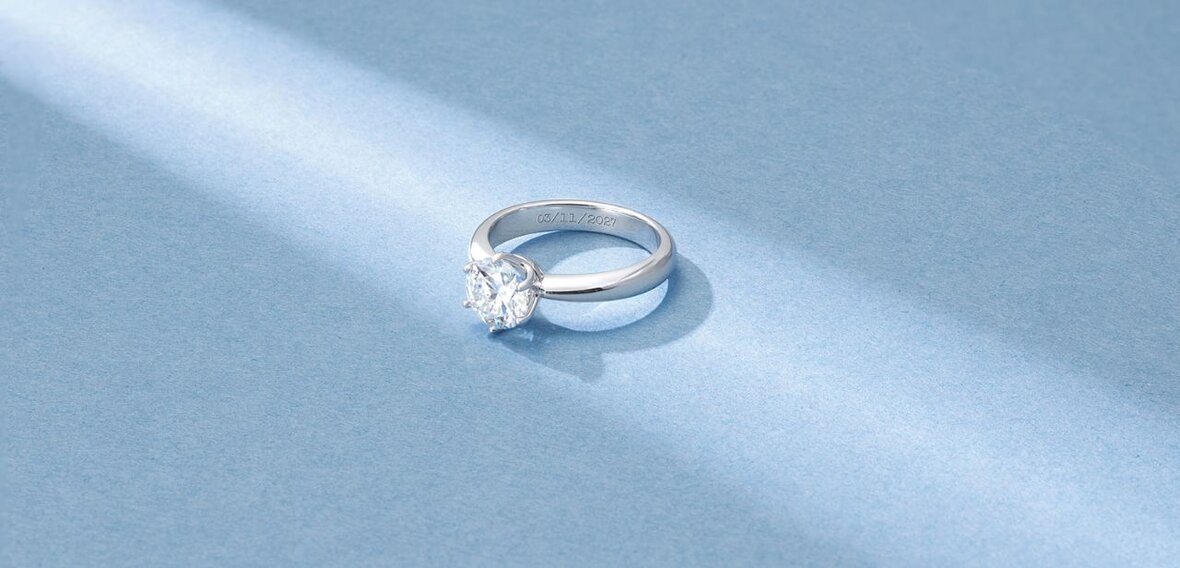 White and yellow gold diamond wedding bands styled on lace fabric, showcasing elegant bridal ring designs by Wedding Bands & Co. in Chicago