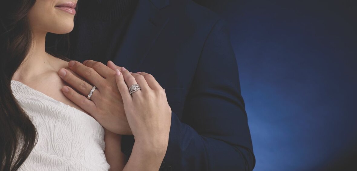 White and yellow gold diamond wedding bands styled on lace fabric, showcasing elegant bridal ring designs by Wedding Bands & Co. in Chicago