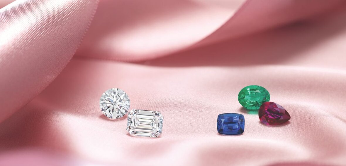 White and yellow gold diamond wedding bands styled on lace fabric, showcasing elegant bridal ring designs by Wedding Bands & Co. in Chicago