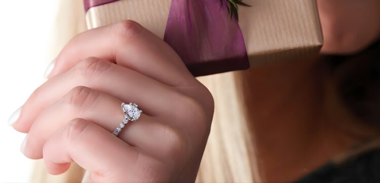 Jeweler working on custom engagement ring CAD design and 3D rendering on computer