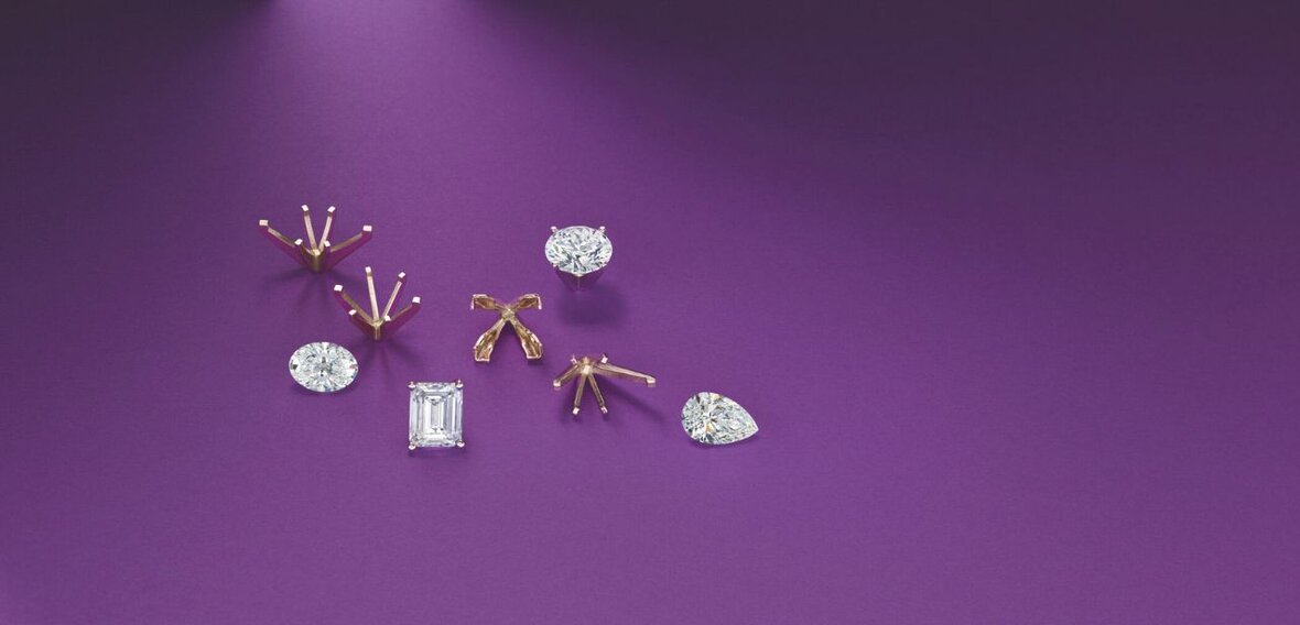 White and yellow gold diamond wedding bands styled on lace fabric, showcasing elegant bridal ring designs by Wedding Bands & Co. in Chicago