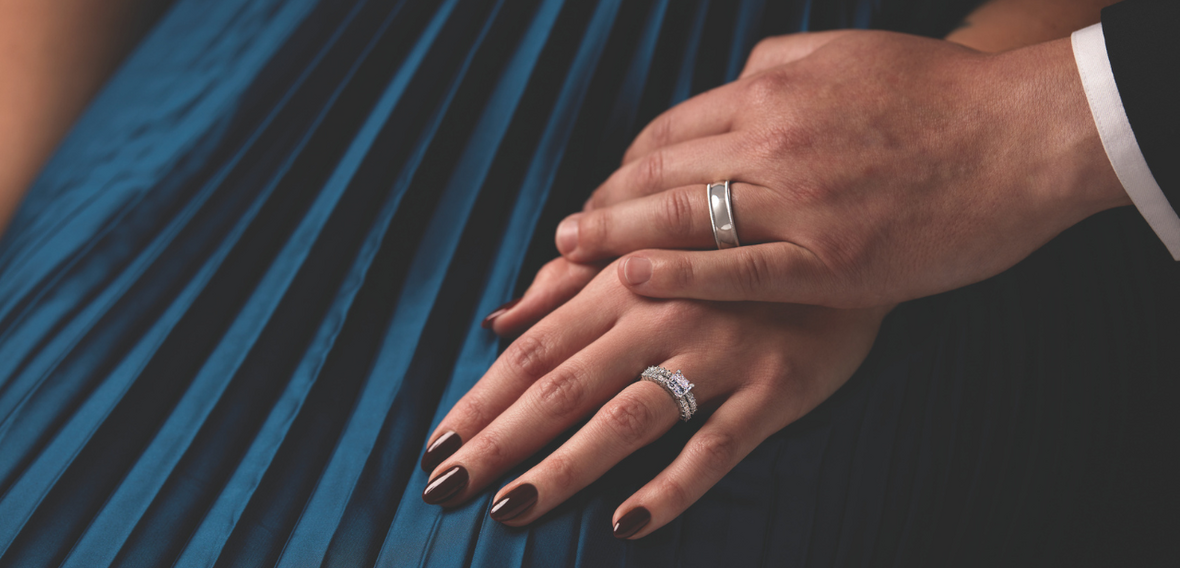 White and yellow gold diamond wedding bands styled on lace fabric, showcasing elegant bridal ring designs by Wedding Bands & Co. in Chicago