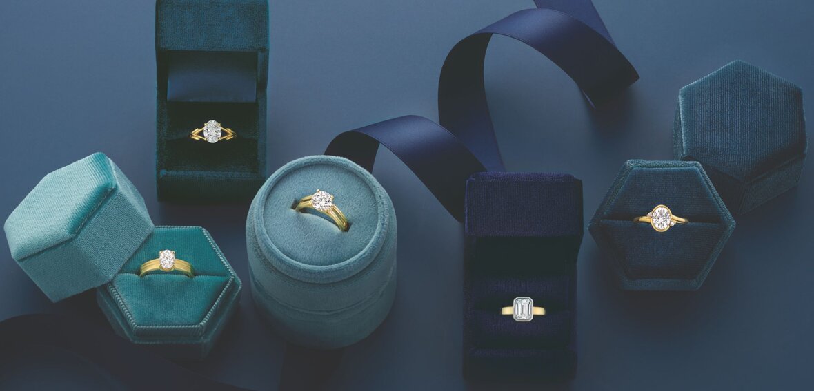 White and yellow gold diamond wedding bands styled on lace fabric, showcasing elegant bridal ring designs by Wedding Bands & Co. in Chicago