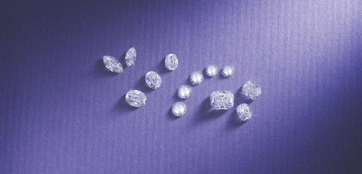 White and yellow gold diamond wedding bands styled on lace fabric, showcasing elegant bridal ring designs by Wedding Bands & Co. in Chicago