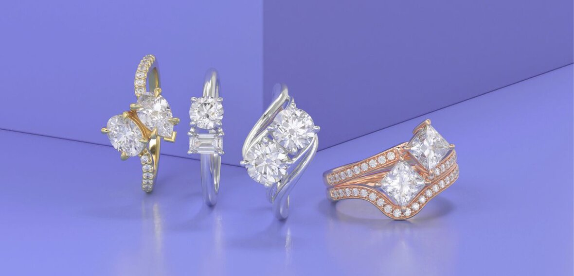 White and yellow gold diamond wedding bands styled on lace fabric, showcasing elegant bridal ring designs by Wedding Bands & Co. in Chicago