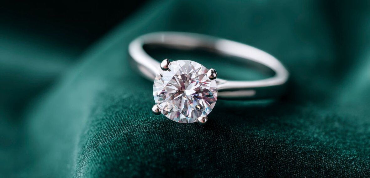 White and yellow gold diamond wedding bands styled on lace fabric, showcasing elegant bridal ring designs by Wedding Bands & Co. in Chicago