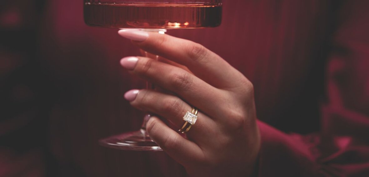 White and yellow gold diamond wedding bands styled on lace fabric, showcasing elegant bridal ring designs by Wedding Bands & Co. in Chicago