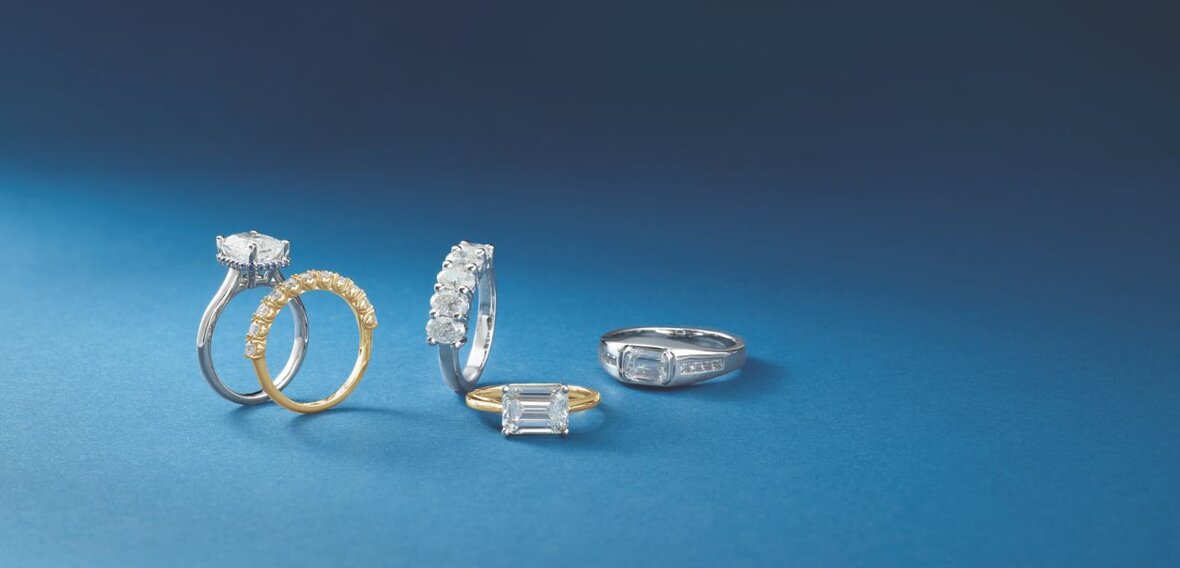 White and yellow gold diamond wedding bands styled on lace fabric, showcasing elegant bridal ring designs by Wedding Bands & Co. in Chicago