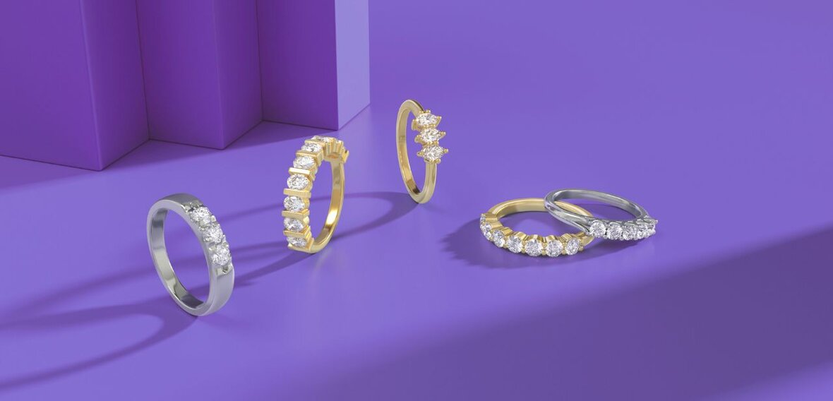 White and yellow gold diamond wedding bands styled on lace fabric, showcasing elegant bridal ring designs by Wedding Bands & Co. in Chicago