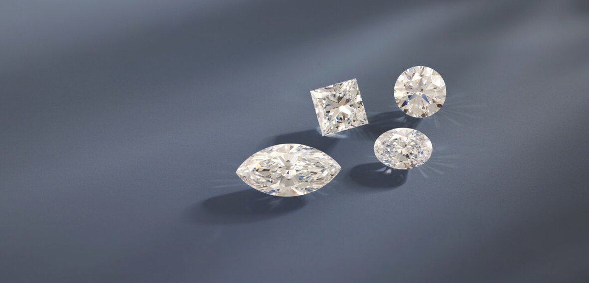 White and yellow gold diamond wedding bands styled on lace fabric, showcasing elegant bridal ring designs by Wedding Bands & Co. in Chicago