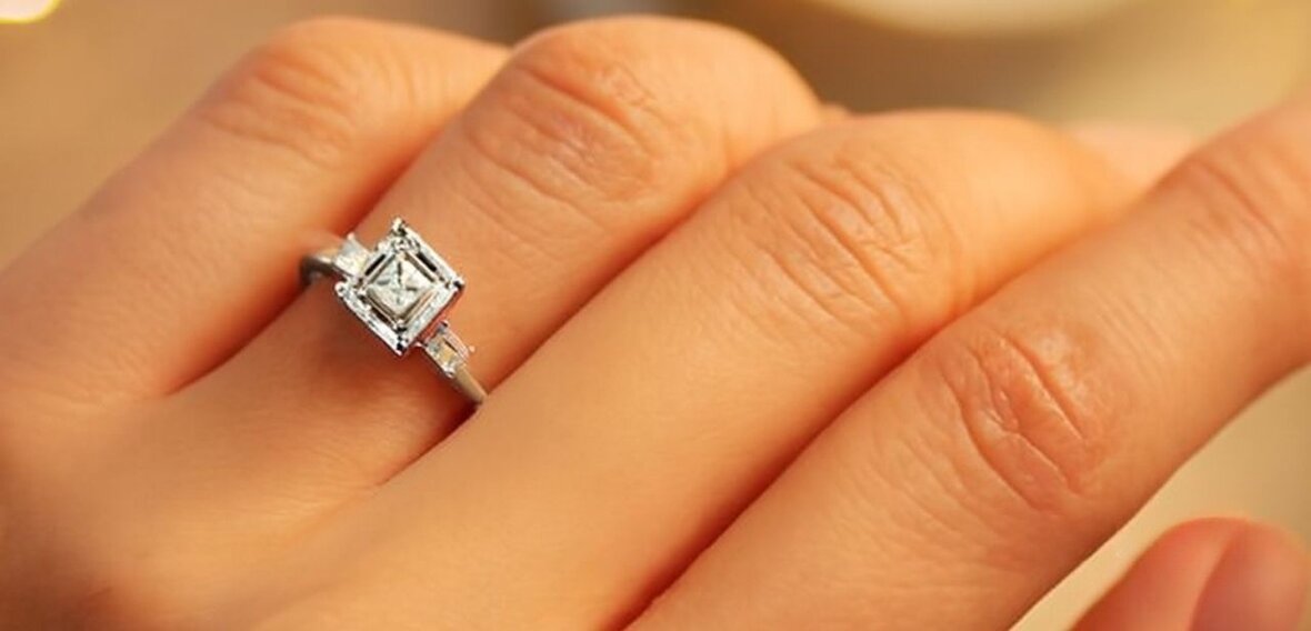 Gold solitaire engagement ring with pavé diamond band representing historical ring craftsmanship