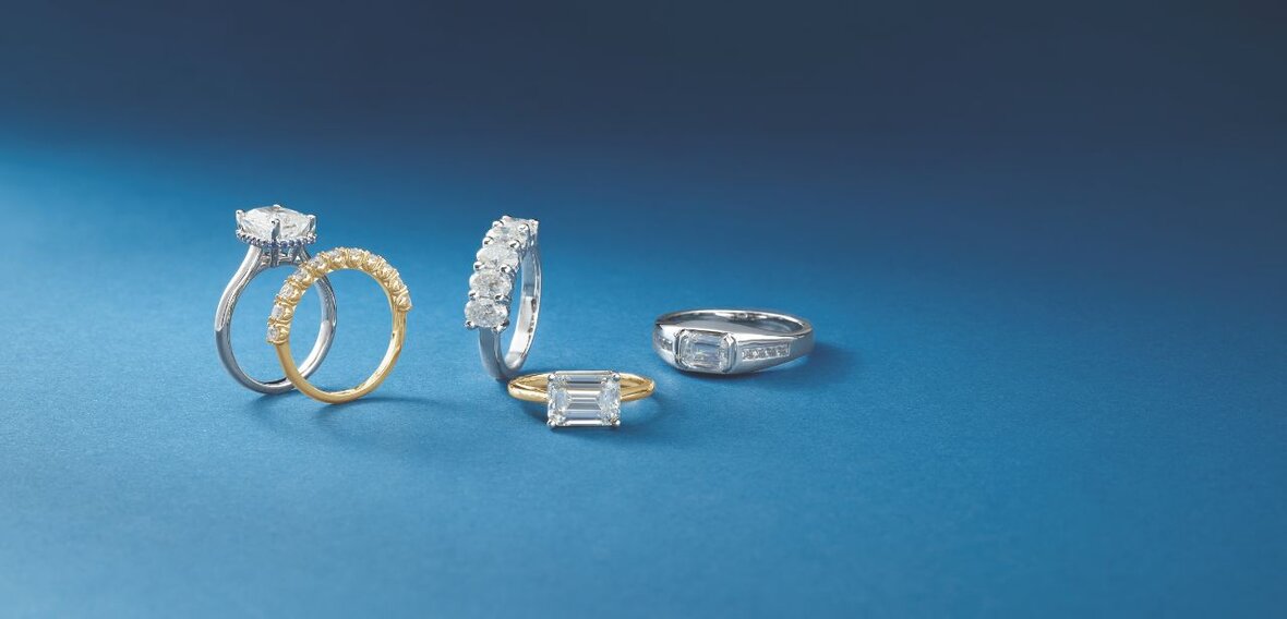 White and yellow gold diamond wedding bands styled on lace fabric, showcasing elegant bridal ring designs by Wedding Bands & Co. in Chicago