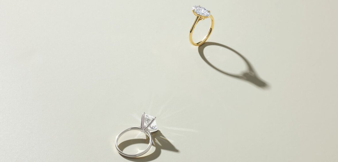 White and yellow gold diamond wedding bands styled on lace fabric, showcasing elegant bridal ring designs by Wedding Bands & Co. in Chicago