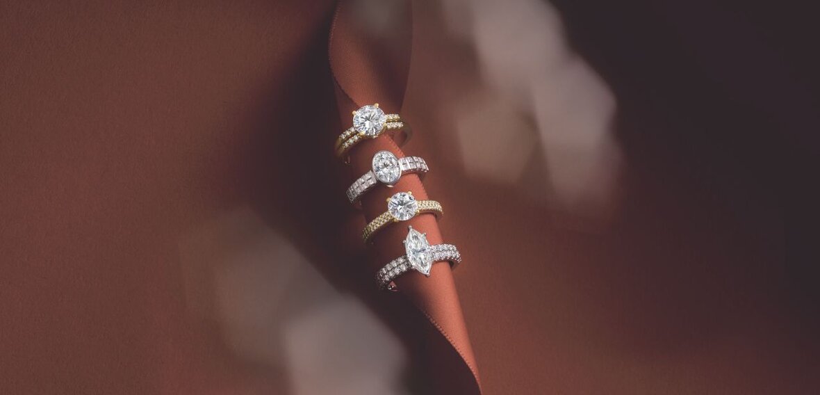 White and yellow gold diamond wedding bands styled on lace fabric, showcasing elegant bridal ring designs by Wedding Bands & Co. in Chicago