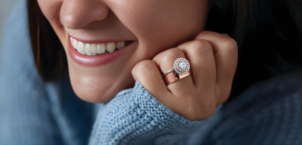 Gold solitaire engagement ring with pavé diamond band paired with matching plain wedding bands