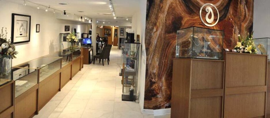 Interior of Wedding Bands & Co. jewelry store in Chicago with display cases, custom rings, and elegant showroom layout