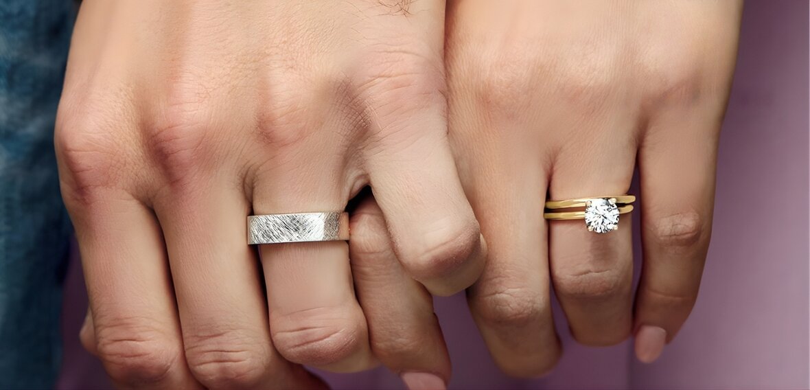 Gold solitaire engagement ring with pavé diamond band and plain wedding bands representing traditional commitment