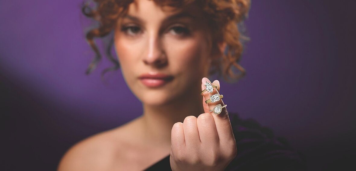 White and yellow gold diamond wedding bands styled on lace fabric, showcasing elegant bridal ring designs by Wedding Bands & Co. in Chicago