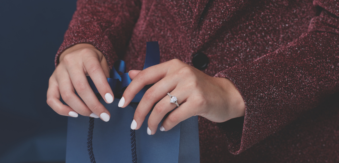 White and yellow gold diamond wedding bands styled on lace fabric, showcasing elegant bridal ring designs by Wedding Bands & Co. in Chicago