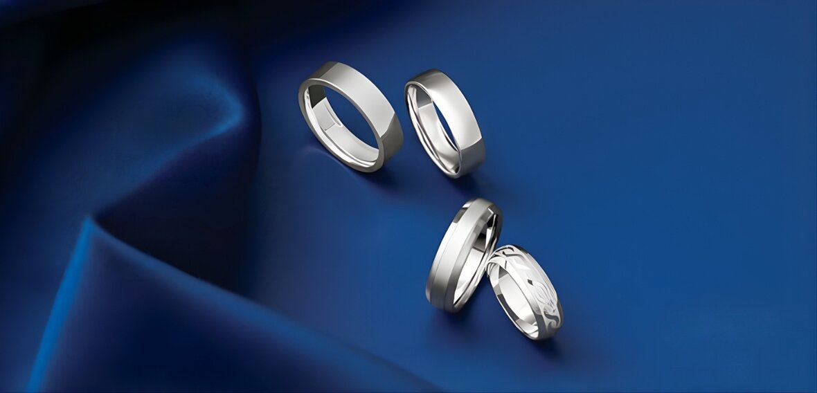 Collection of modern wedding bands in yellow gold, white gold, and platinum with various textures and finishes