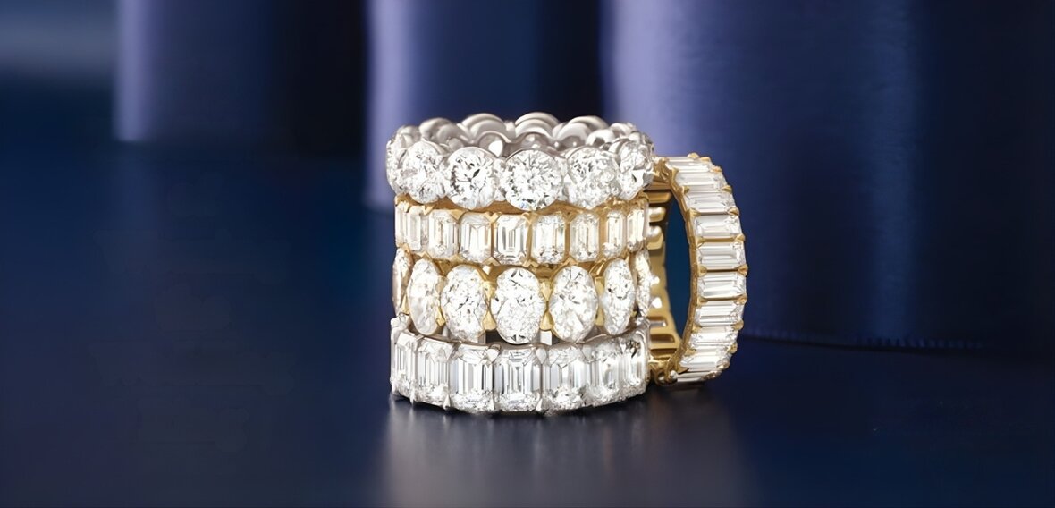 Gold engagement ring with pavé diamond band stacked with wedding bands showing traditional ring placement