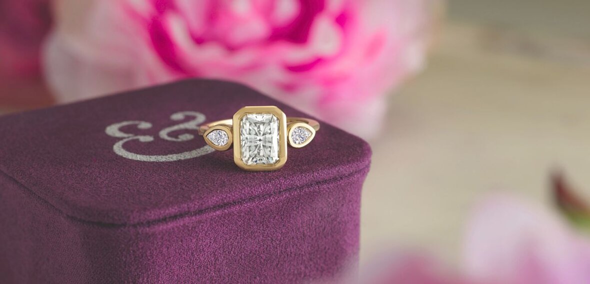 White and yellow gold diamond wedding bands styled on lace fabric, showcasing elegant bridal ring designs by Wedding Bands & Co. in Chicago