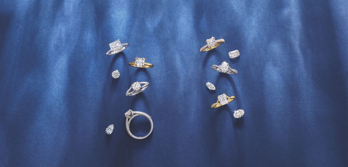 White and yellow gold diamond wedding bands styled on lace fabric, showcasing elegant bridal ring designs by Wedding Bands & Co. in Chicago