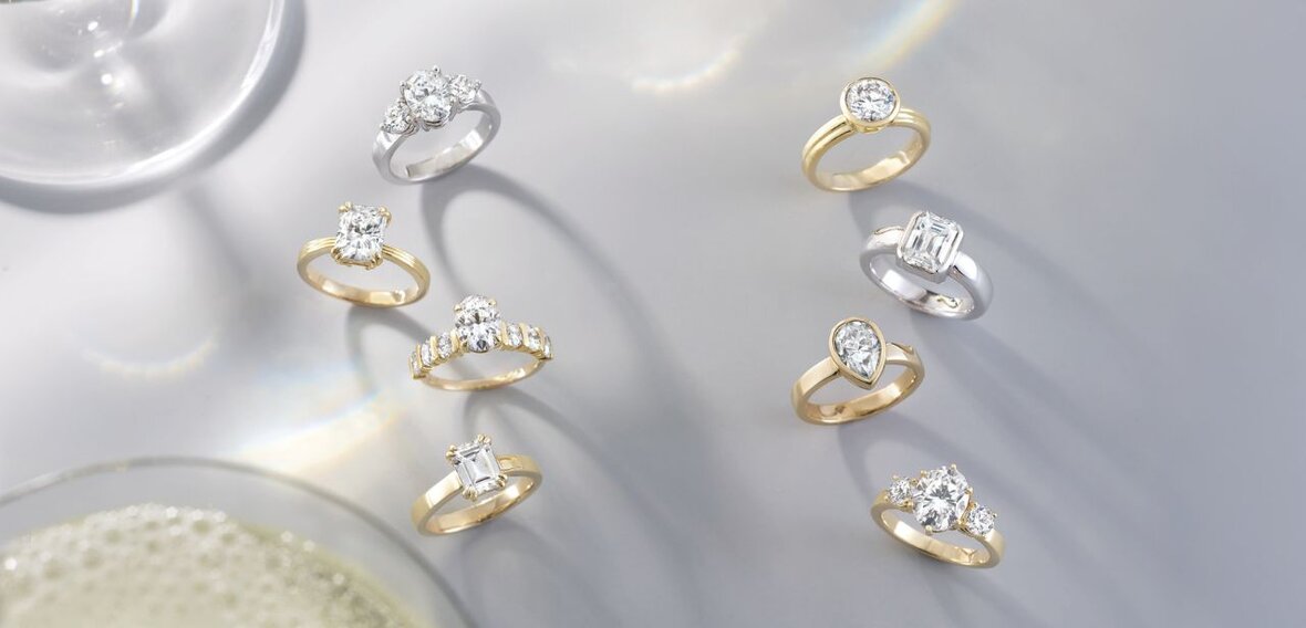 White and yellow gold diamond wedding bands styled on lace fabric, showcasing elegant bridal ring designs by Wedding Bands & Co. in Chicago