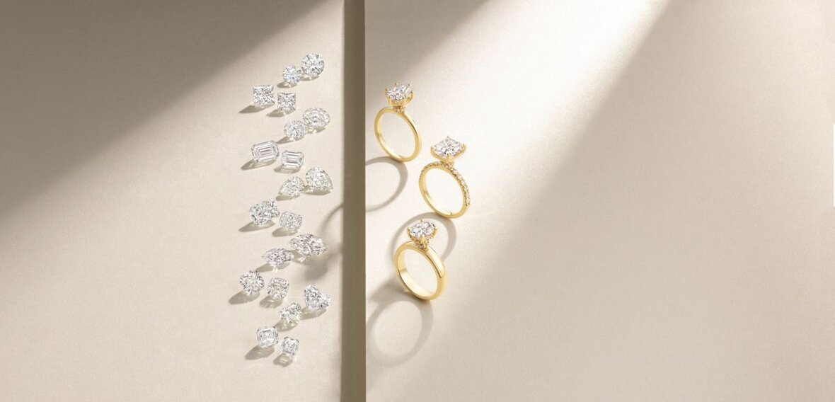 White and yellow gold diamond wedding bands styled on lace fabric, showcasing elegant bridal ring designs by Wedding Bands & Co. in Chicago