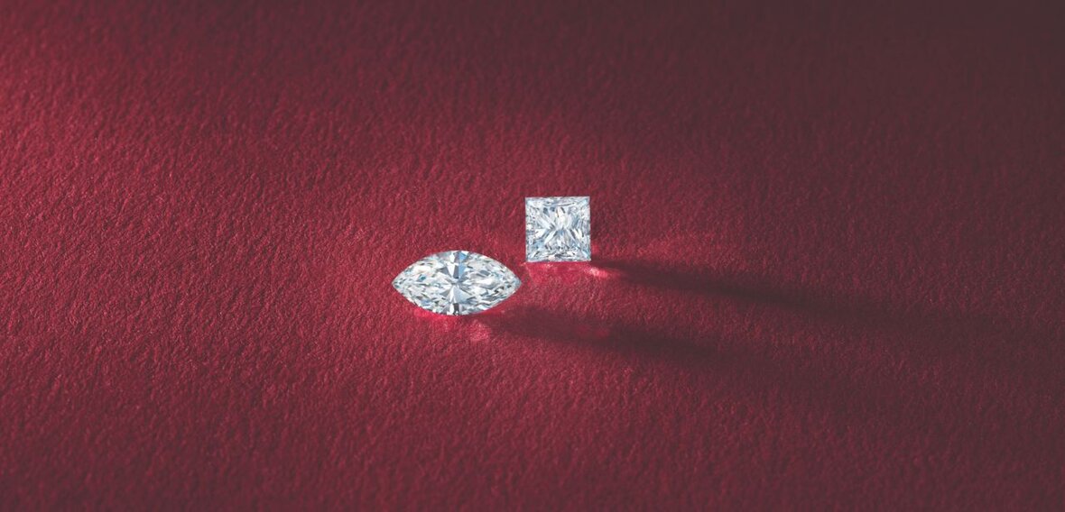 White and yellow gold diamond wedding bands styled on lace fabric, showcasing elegant bridal ring designs by Wedding Bands & Co. in Chicago