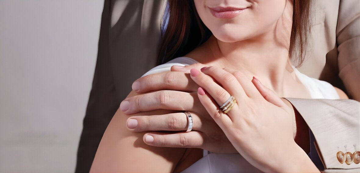 Gold solitaire engagement ring with pavé diamond band demonstrating traditional wedding ring placement