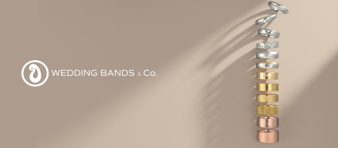 Vertical display of wedding bands in platinum, white gold, yellow gold, and rose gold showing metal options by Wedding Bands & Co. in Chicago