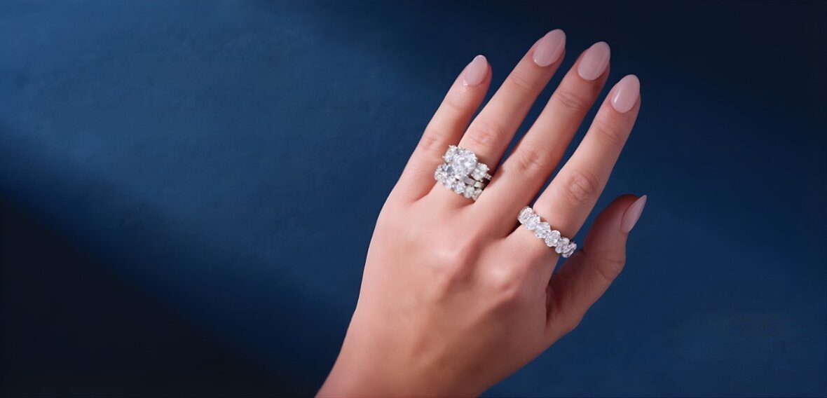 White and yellow gold diamond wedding bands on lace fabric representing different cultural traditions