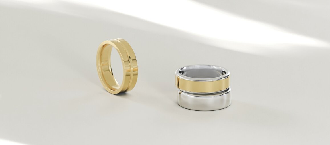 Yellow gold wedding band and two-tone gold and platinum wedding rings displayed on a neutral surface for home wedding ring care and maintenance guidance